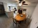 Dining area with table and chairs, adjacent to kitchen at 5587 Devonbriar Way # 105, Orlando, FL 32822