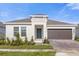 One-story home with a two-car garage and well-manicured landscaping at 4945 Worchester Dr, Kissimmee, FL 34746