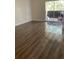 Bright living room featuring wood-look floors and access to a patio at 914 Lake Destiny Rd # H, Altamonte Springs, FL 32714