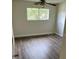 Spacious bedroom with wood-look floors and a large window at 914 Lake Destiny Rd # H, Altamonte Springs, FL 32714
