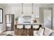 Modern kitchen with white cabinets, marble island, and gold accents at 33 S Graham Ave, Orlando, FL 32803