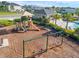 Community playground with playset, swings, and shade structure near pool at 2723 Plume Rd, Clermont, FL 34711