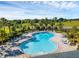 Community pool with surrounding lounge chairs and landscaping at 2723 Plume Rd, Clermont, FL 34711