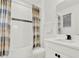 Clean bathroom with shower/tub combo and white vanity at 2723 Plume Rd, Clermont, FL 34711