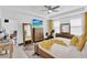 Relaxing bedroom featuring a king-size bed and large TV at 2723 Plume Rd, Clermont, FL 34711