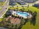 Aerial view of community pool, playground, and homes at 2723 Plume Rd, Clermont, FL 34711