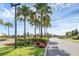 Landscaped entrance to the community with palm trees and stonework at 2723 Plume Rd, Clermont, FL 34711