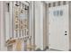 Bright entryway with glass-top console table, mirror, and striped wallpaper at 2723 Plume Rd, Clermont, FL 34711
