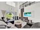 Open living area with a sectional sofa, large TV, and high ceilings at 2723 Plume Rd, Clermont, FL 34711