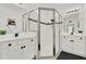Modern bathroom with a double vanity and a large walk-in shower at 2723 Plume Rd, Clermont, FL 34711