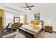 Spacious bedroom with a king-size bed, dresser, and workout equipment at 2723 Plume Rd, Clermont, FL 34711