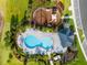 Community pool with surrounding lounge chairs and a playground nearby at 2723 Plume Rd, Clermont, FL 34711