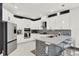 Modern kitchen with white cabinets, stone backsplash and island at 2723 Plume Rd, Clermont, FL 34711