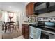 Kitchen with dark wood cabinets and stainless steel appliances at 1069 S Hiawassee Rd # 1336, Orlando, FL 32835