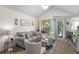 Living room with light-colored sofa and vaulted ceiling at 1069 S Hiawassee Rd # 1336, Orlando, FL 32835