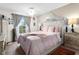 Main bedroom with a canopy bed and plenty of natural light at 1069 S Hiawassee Rd # 1336, Orlando, FL 32835
