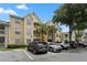 Three-story yellow building with parking and landscaping at 1069 S Hiawassee Rd # 1336, Orlando, FL 32835