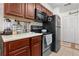 View of kitchen with stainless steel appliances and wood cabinets at 1069 S Hiawassee Rd # 1336, Orlando, FL 32835