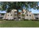 Three-story yellow building with balconies and trees at 1069 S Hiawassee Rd # 1336, Orlando, FL 32835