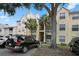 Three-story yellow building with balconies and parking at 1069 S Hiawassee Rd # 1336, Orlando, FL 32835