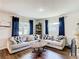 Bright living room with sectional sofa, coffee table, and hardwood floors at 240 People St, Maitland, FL 32751