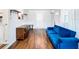 Living room features hardwood floors, a blue velvet couch, and a wooden media console at 240 People St, Maitland, FL 32751
