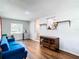 Bright living room with hardwood floors, blue couch, and built-in shelving at 240 People St, Maitland, FL 32751