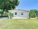 House exterior boasts a freshly painted facade and nicely landscaped lawn at 240 People St, Maitland, FL 32751