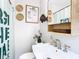 Updated bathroom features a pedestal sink, stylish fixtures, and a decorative shower curtain at 240 People St, Maitland, FL 32751