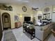 Spacious living room with a large TV, comfortable seating, and high ceilings at 531 Soft Shadow Ln, Debary, FL 32713