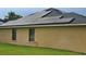 Home exterior showcasing solar panels and green lawn at 531 Soft Shadow Ln, Debary, FL 32713