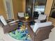 Peaceful patio with wicker furniture and a circular rug at 531 Soft Shadow Ln, Debary, FL 32713