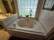 Relaxing bathroom with a large garden tub and updated fixtures at 531 Soft Shadow Ln, Debary, FL 32713
