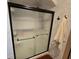 Bathroom with a sliding glass shower door and tiled walls at 531 Soft Shadow Ln, Debary, FL 32713