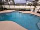 Inviting pool area with screened enclosure, comfortable seating, and lush landscaping at 531 Soft Shadow Ln, Debary, FL 32713
