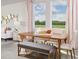 Dining area with wood table and bench seating, natural light at 1365 Current Pl, Haines City, FL 33844
