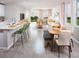 Open concept dining area with wood table and view to living room at 1365 Current Pl, Haines City, FL 33844