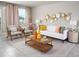 Living room with comfy seating, large windows, and stylish decor at 1365 Current Pl, Haines City, FL 33844