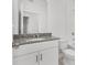 Bathroom with granite countertop, white cabinets, and bathtub at 2482 Leeds St, Haines City, FL 33844