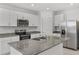 Modern kitchen with stainless steel appliances and granite countertops at 2482 Leeds St, Haines City, FL 33844