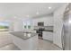 Open concept kitchen featuring granite island and stainless steel appliances at 2482 Leeds St, Haines City, FL 33844