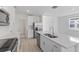 Modern kitchen with white cabinets, quartz counters, and stainless steel appliances at 2109 Judith Ct, Haines City, FL 33844