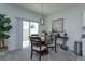 Bright dining area with a round table and chairs, near sliding glass doors at 190 Mandovi St, Davenport, FL 33837