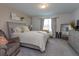Main bedroom with large bed, comfortable seating and plenty of natural light at 190 Mandovi St, Davenport, FL 33837