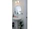Clean bathroom featuring a pedestal sink and round mirror at 190 Mandovi St, Davenport, FL 33837