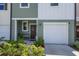 Townhome's exterior features a front entrance, attached garage, and well-maintained landscaping at 190 Mandovi St, Davenport, FL 33837