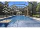 Relaxing pool with a covered patio, safety fence, and umbrella at 1560 Eagle Nest Cir, Winter Springs, FL 32708