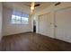 Bright bedroom with wood-look floors, ceiling fan, and ample closet space at 111 Lake Dot Dr, Sanford, FL 32773