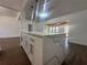 Modern kitchen island with waterfall edge quartz countertop and white cabinets at 111 Lake Dot Dr, Sanford, FL 32773