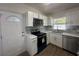 Modern kitchen with white shaker cabinets, quartz countertops and stainless steel appliances at 111 Lake Dot Dr, Sanford, FL 32773